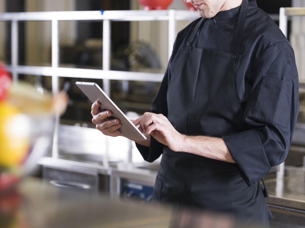 chef-orders-products-on-tablet-photo